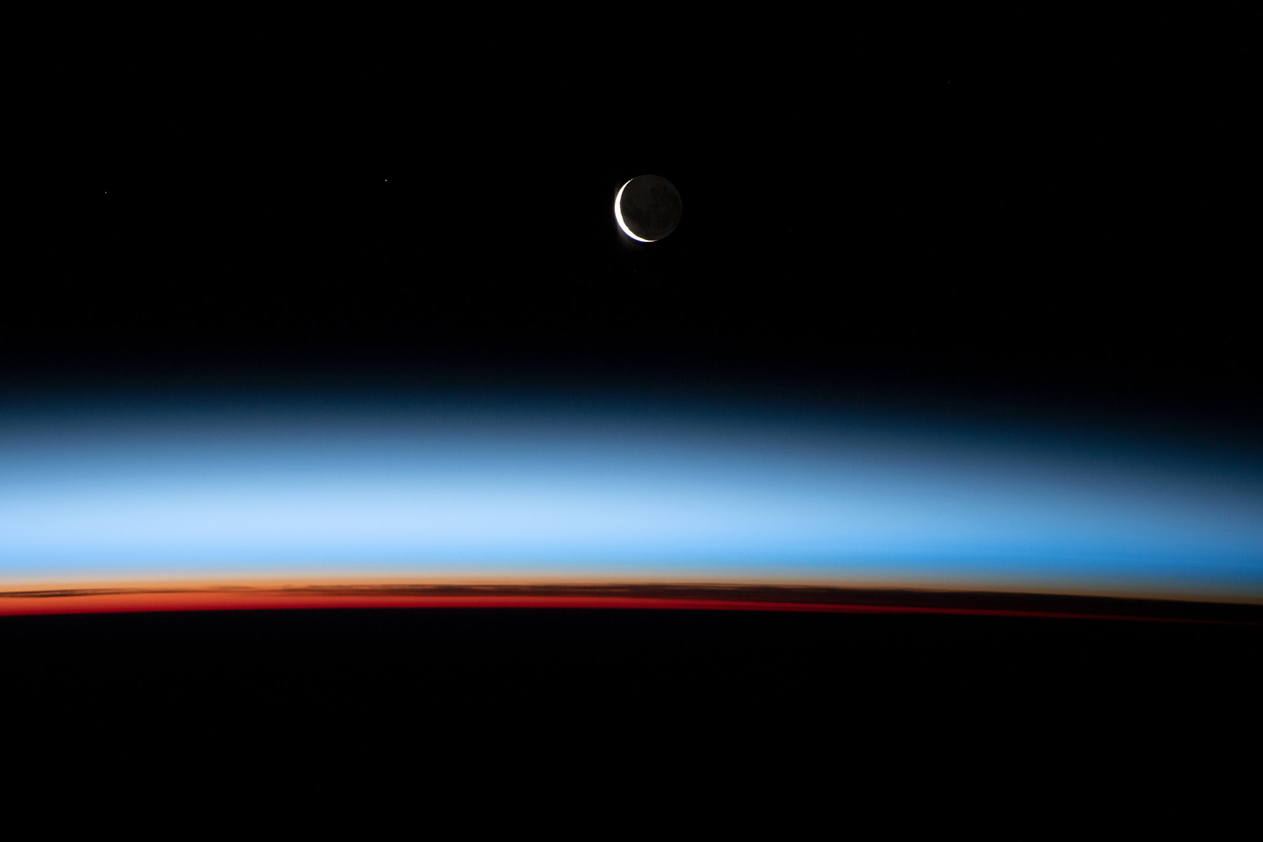 This stunning crescent moon was captured by astronauts aboard the ISS with a Nikon D5